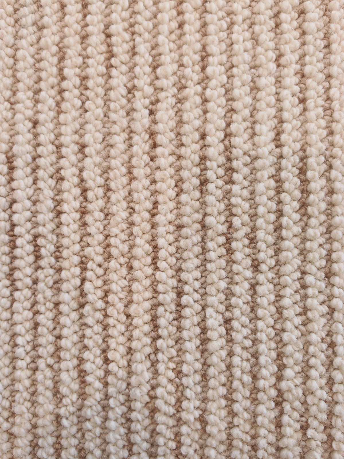 The Glint rug's ribbed surface, with rows of oatmeal loops running its length.