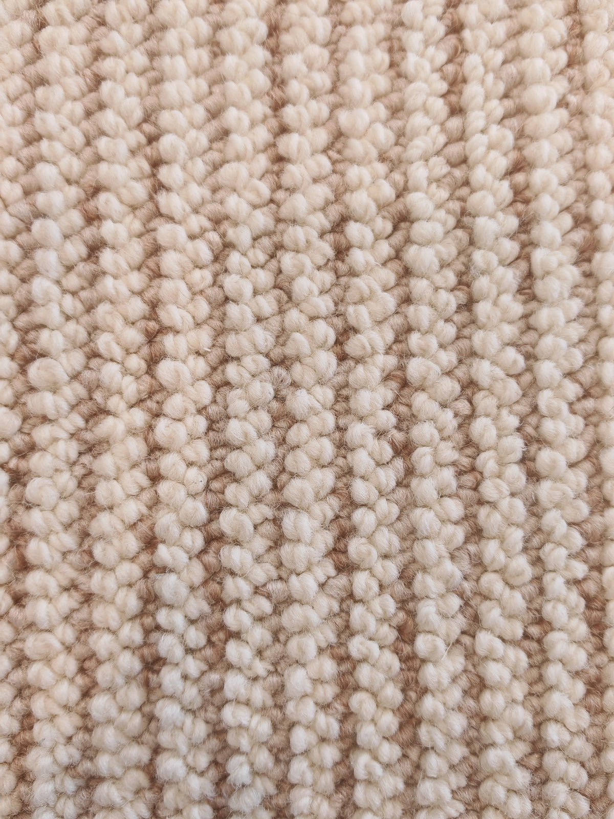 The Glint rug's ribbed loops in rows of cream and soft caramel.