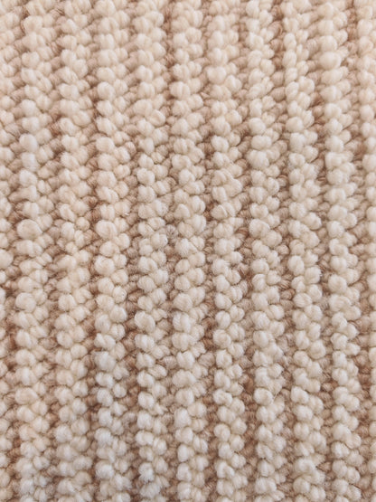 The Glint rug's ribbed loops in rows of cream and soft caramel.