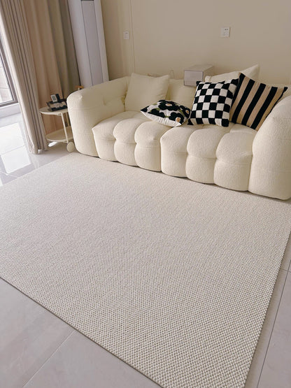 Halcyon rug in front of a cream bouclé sofa with black-and-white cushions.